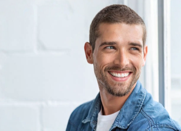 Patient smiling after dental implant treatment